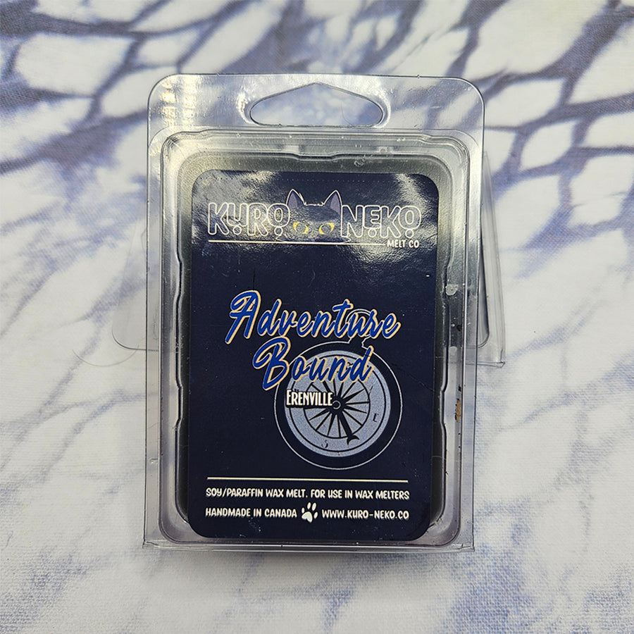 A set of wax melts in a clamshell on a dark blue and white tie dye background. The pictured scent is Adventure Bound: Erenville.