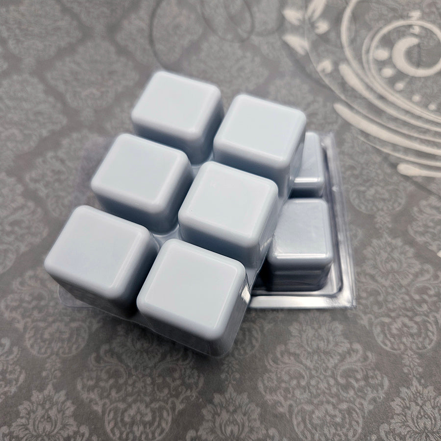 A set of wax melts in a clamshell on a dark grey patterned background. The pictured scent is Home Beyond the Horizon: Garlemald.