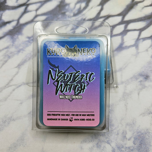 A set of wax melts in a clamshell on a dark blue and white tie dye background. The pictured scent is Claws in Neoteric Witch: Wicked Thunder.