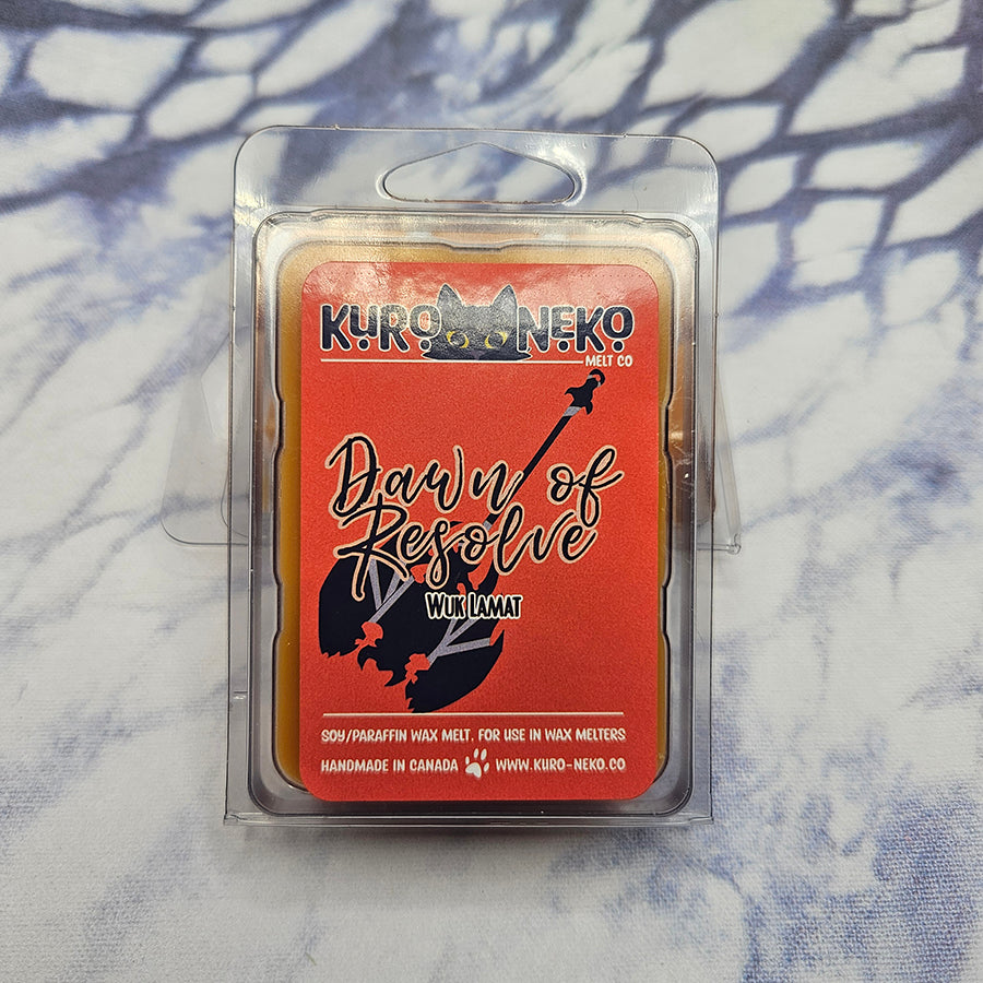 A set of wax melts in a clamshell on a dark blue and white tie dye background. The pictured scent is Dawn of Resolve: Wuk Lamat.